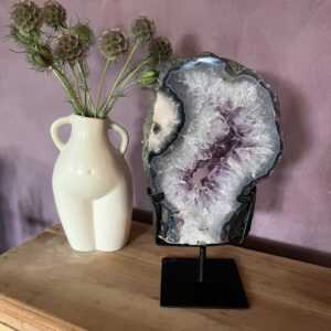 Paarse amethist edelsteen helder en glanzend, Amethist steen met diepe paarse kleur, Amethist kristal voor rust en bescherming, Close-up van amethist met natuurlijke structuur, Amethist steen die intuïtie en balans bevordert, Prachtige paarse amethist voor spiritueel gebruik, Amethist portaal op standaard