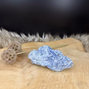 Kyaniet Ruw met een glanzende gelaagde structuur van 9 cm lang, Detail van de diepblauwe banen in een ruwe Kyaniet steen van 140 gram, Kyaniet mineraal met een trikliene kristalvorm op een lichte achtergrond, Blauwe Kyaniet Ruw voor rust en heldere communicatie in huis.